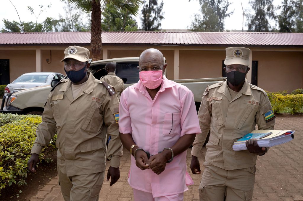 "Hotel Rwanda" hero Paul Rusesabagina (C) in the pink inmate's uniform arriving at Nyarugenge Court of Justice in Kigali, Rwanda, on October 2, 2020, surrounded by guards of Rwanda Correctional Service (RCS). - He will receive a decision from the court about his request for bail, based on his fragile health conditions. Paul Rusesabagina faces 13 charges including terrorism for being part of MRCD political platform. (Photo by Simon Wohlfahrt / AFP) (Photo by SIMON WOHLFAHRT/AFP via Getty Images)