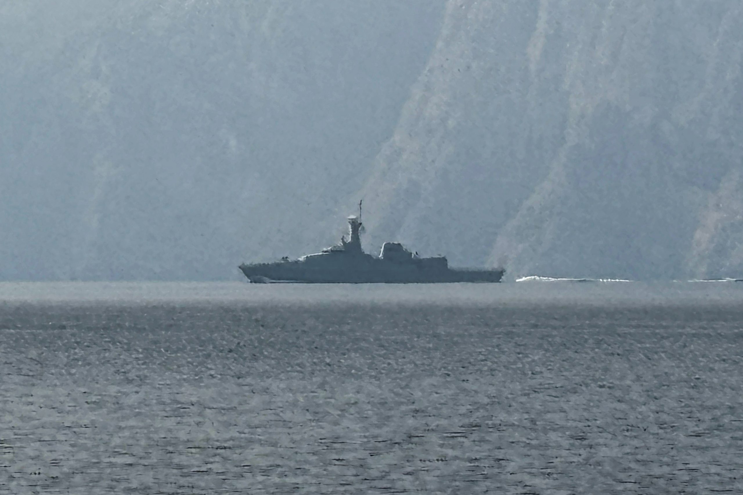 A navy vessel is seen sailing in the Strait of Hormuz, a vital waterway through which much of the world's oil and gas passes on March 1, 2026. Two ships were attacked in the Strait of Hormuz on March 1, maritime security agencies said, as Iran pressed a second day of strikes in response to US-Israeli military strikes on Iran killing it's supreme leader. (Photo by Sahar AL ATTAR / AFP)