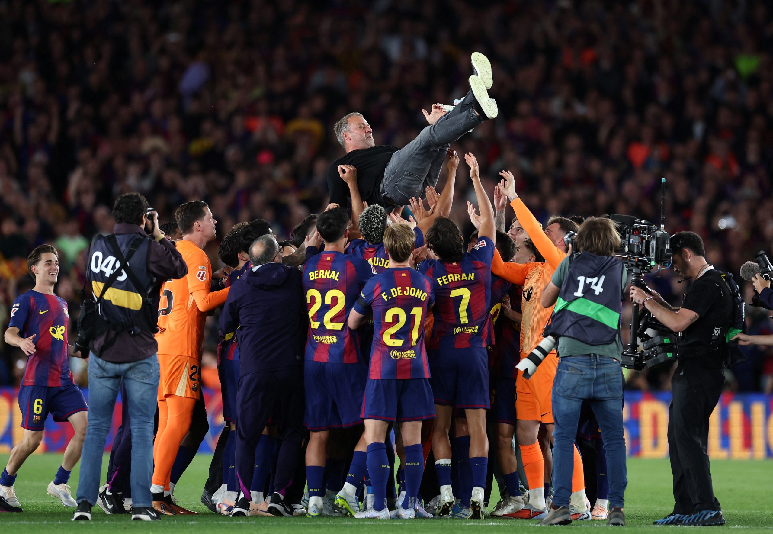 Barcelona's players celebrate with Barcelona's German coach Hans-Dieter Flick winning the Spanish league football match between FC Barcelona and Real Madrid CF at Camp Nou Stadium in Barcelona on May 10, 2026. Barcelona won 2-0. (Photo by Josep LAGO / AFP)