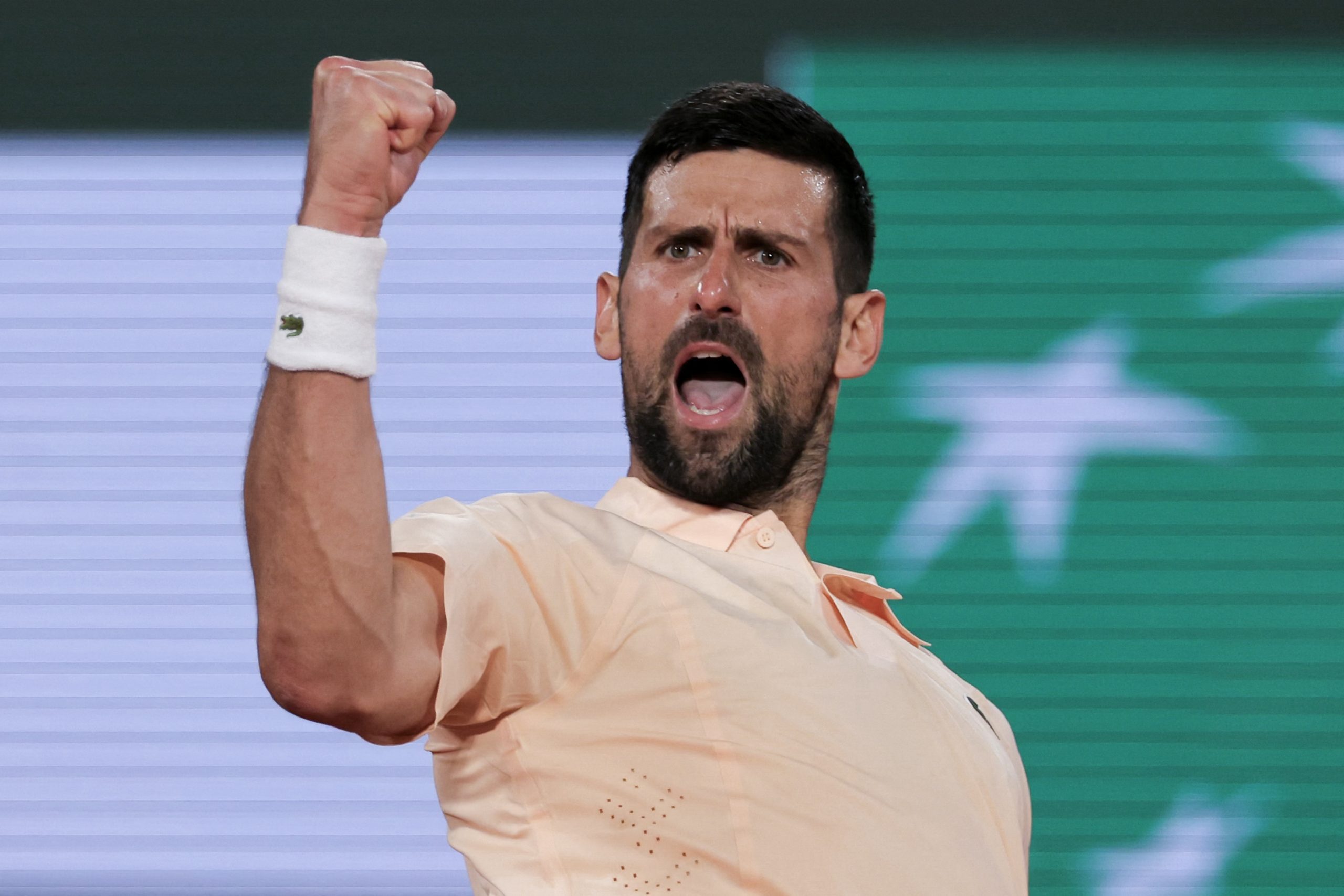 Serbia's Novak Djokovic celebrates after winning against France's Giovanni Mpetshi Perricard at the end of their men's singles match on day 1 of the French Open tennis tournament on Court Philippe-Chatrier at the Roland-Garros Complex in Paris on May 24, 2026. (Photo by Thomas SAMSON / AFP)