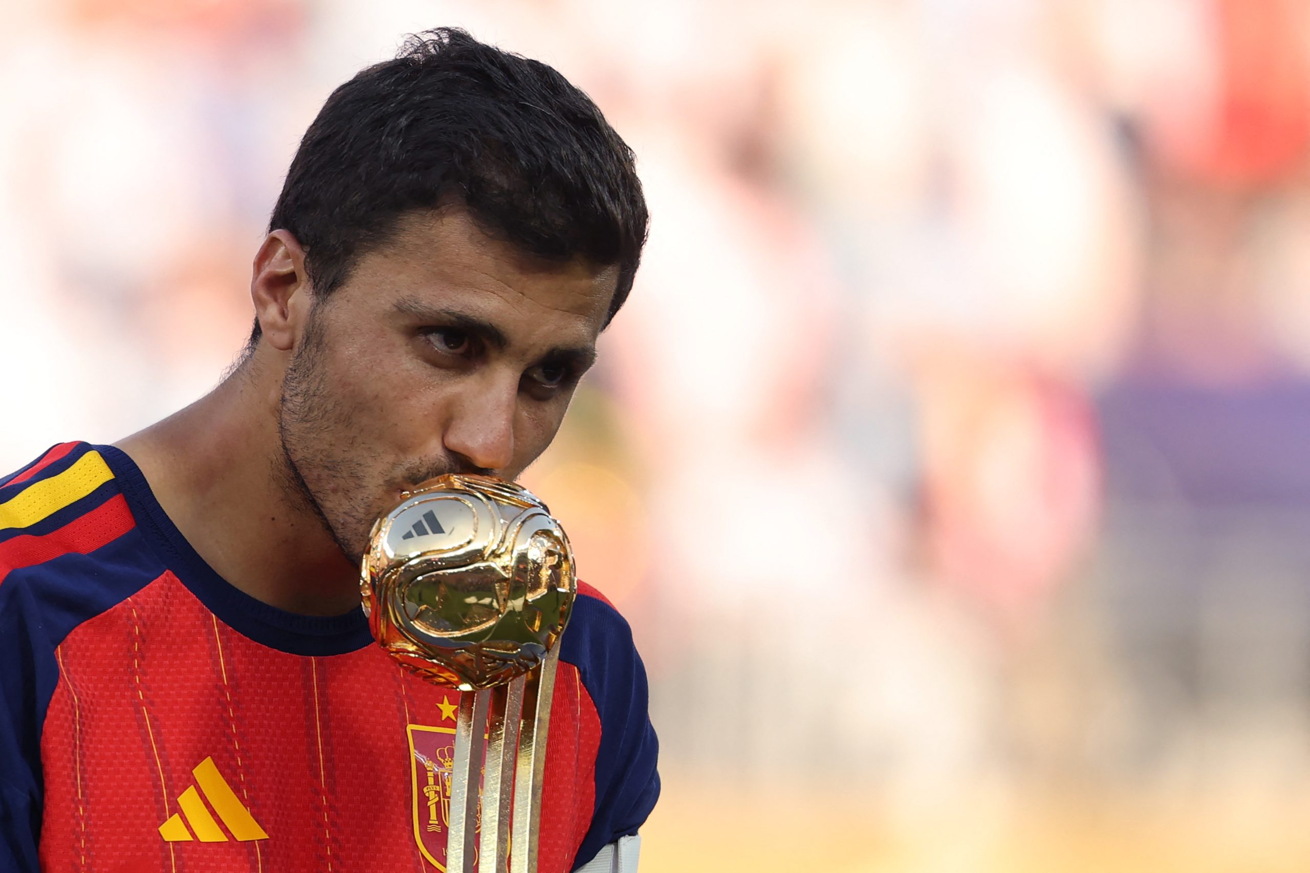Spain's midfielder #16 Rodri kisses the Golden Ball Award during the award ceremony of the 2026 World Cup football tournament final match between Spain and Argentina at the New York/New Jersey Stadium in East Rutherford on July 19, 2026.  (Photo by Odd ANDERSEN / AFP)